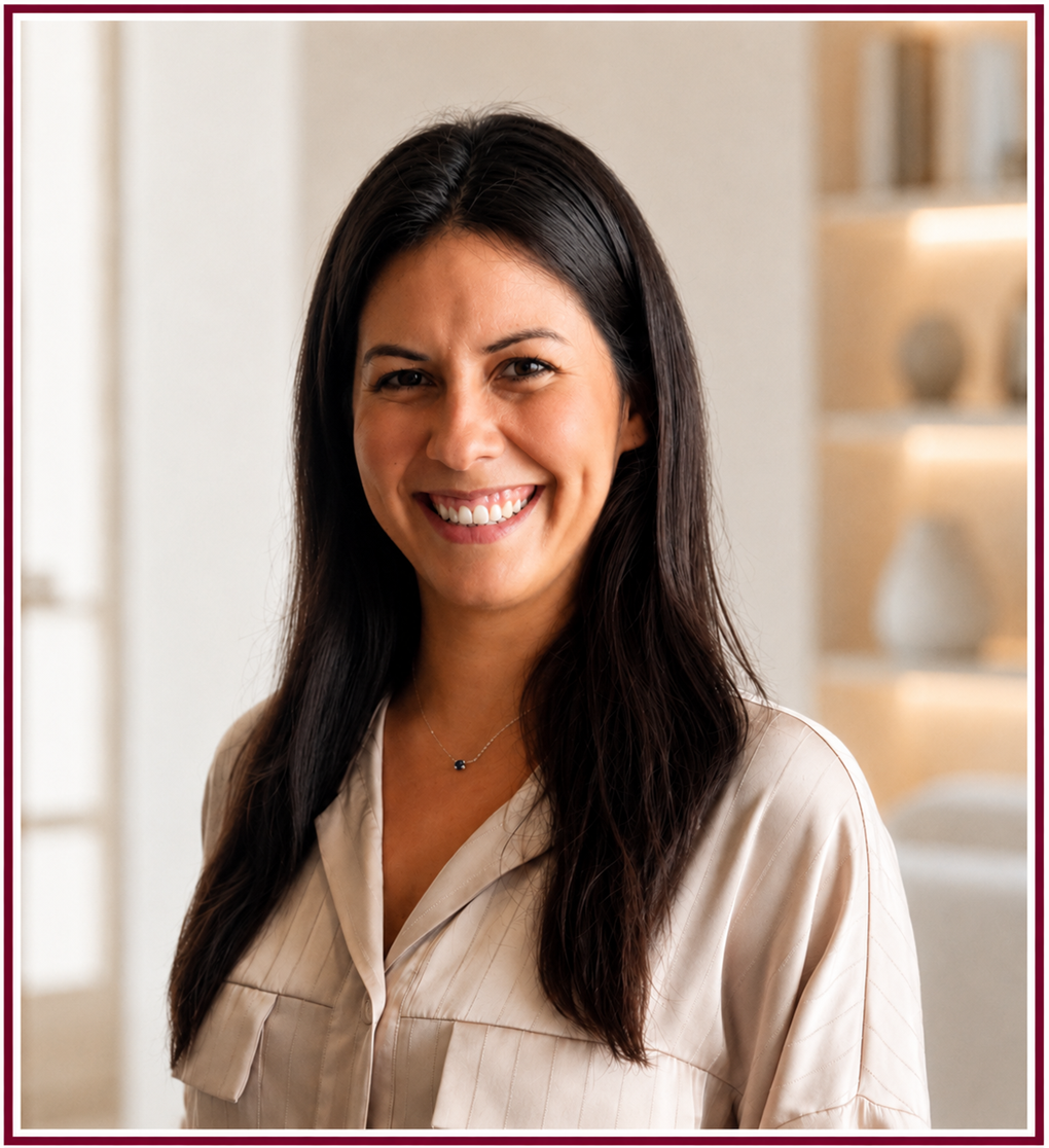 Karina The Nanny Booth 2 - The Nanny Booth Portrait of a smiling woman with long dark hair wearing a beige blouse, indoors.